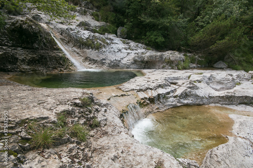 View of The Cadini del Brenton. Deep cavities dug by the waters of the stream forming small and clear waterfalls. These spectacular pot holes, situated in the heart of Dolomiti Bellunesi National Park photo