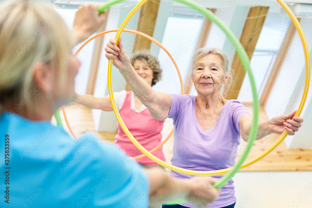 © Robert Kneschke - Seniors doing fitness training with hoops