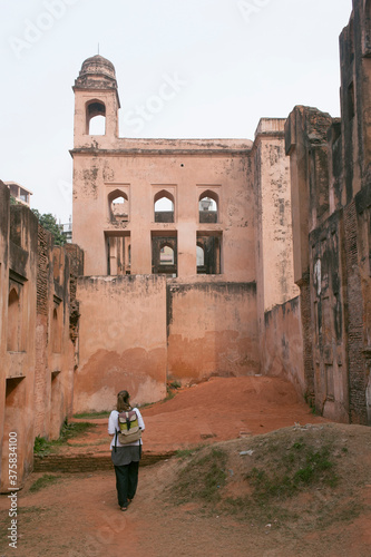 A young traveller walking by an old fort in Asia. photo