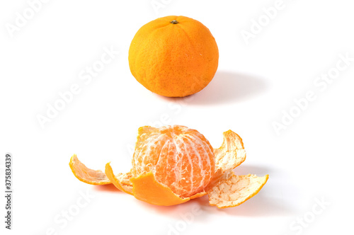 Orange and peeled orange on white background