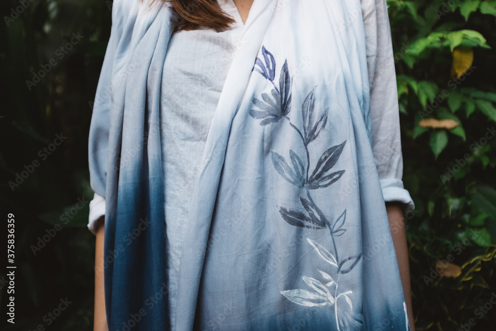 Detail of a Blue Painted Scarf with a Flower Print Detail of a Blue Painted Scarf with a Flower Print