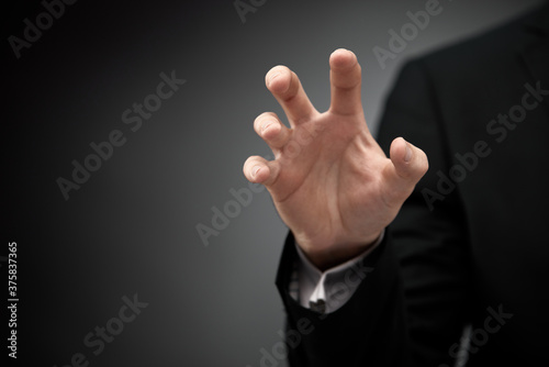 Businessman gesturing as of he's holding something