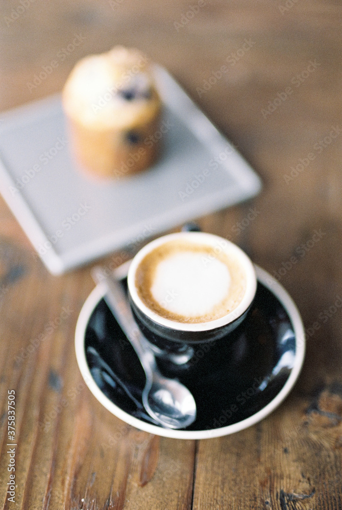 Coffee and a muffin on the table Coffee and a muffin on the table