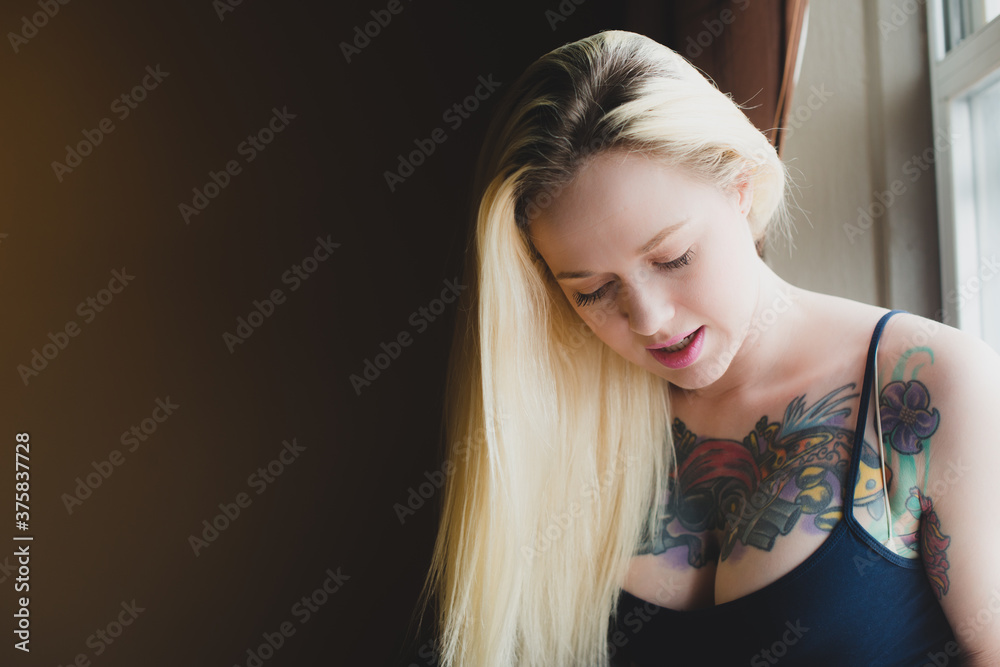 Woman sitting by the window at home