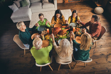 Top above high angle view of nice attractive adorable big full family parents sitting around served table praying grace festal occasion at modern loft wooden industrial interior house indoors