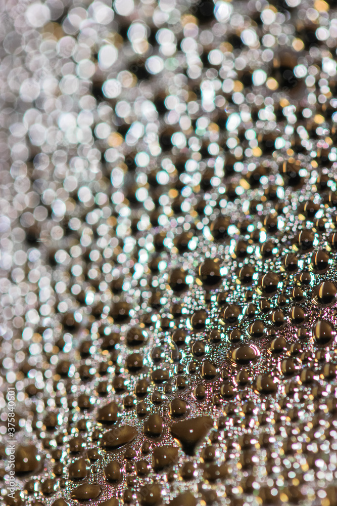 Many colorful little bubbles on the glass surface close-up Many colorful little bubbles on the glass surface close-up