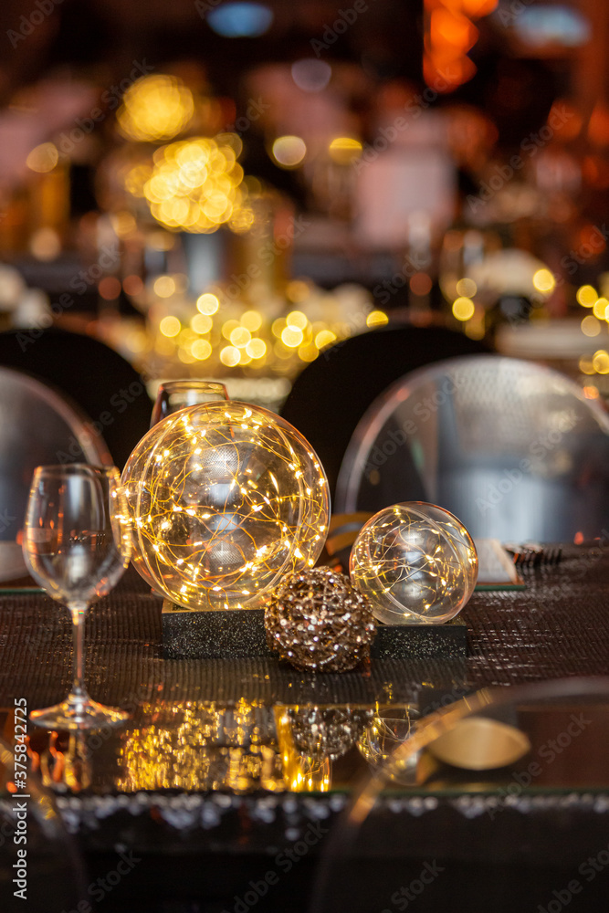 Fairy lights in a glass dome on a table for an event.