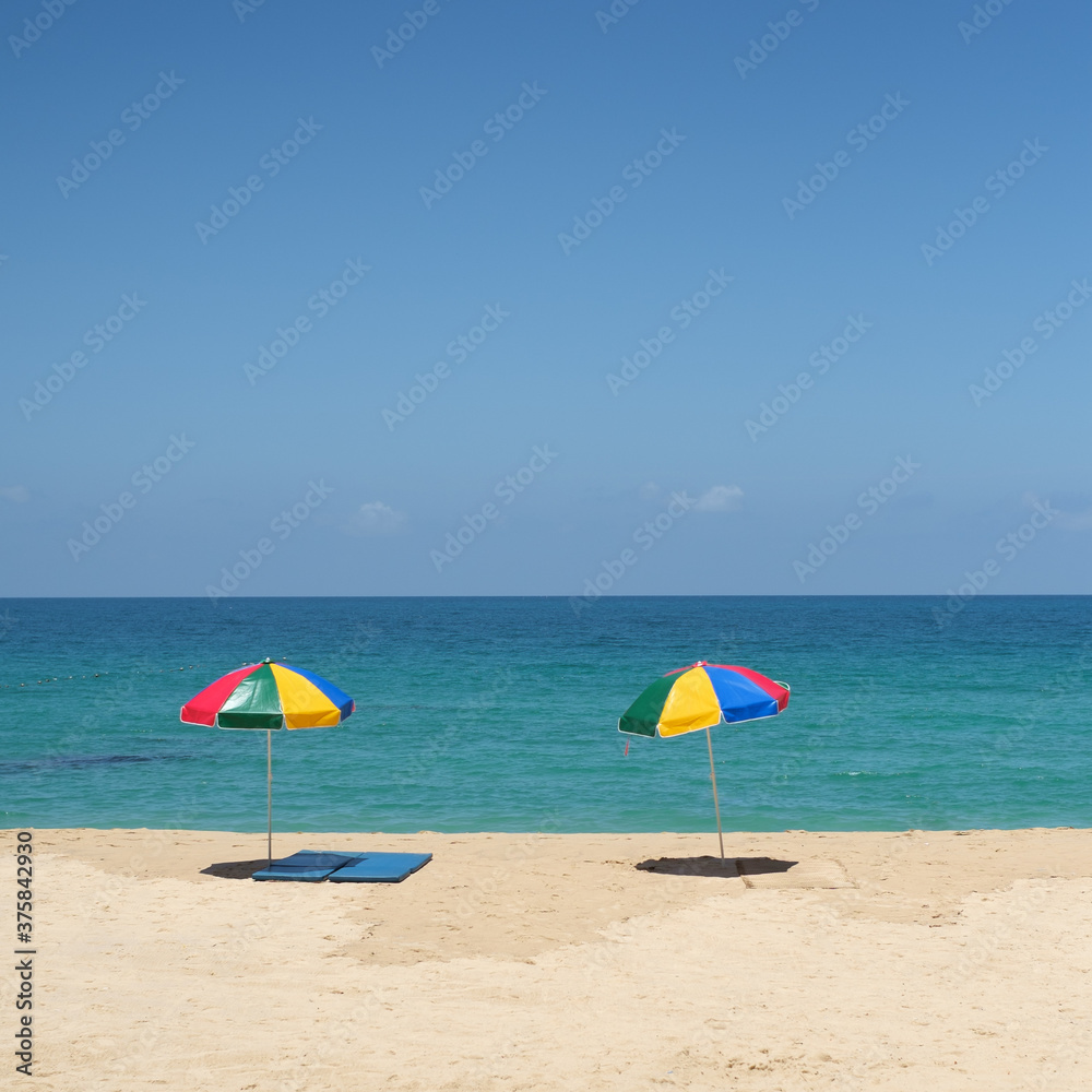 Two Colorful Parasols on the Beach Two Colorful Parasols on the Beach