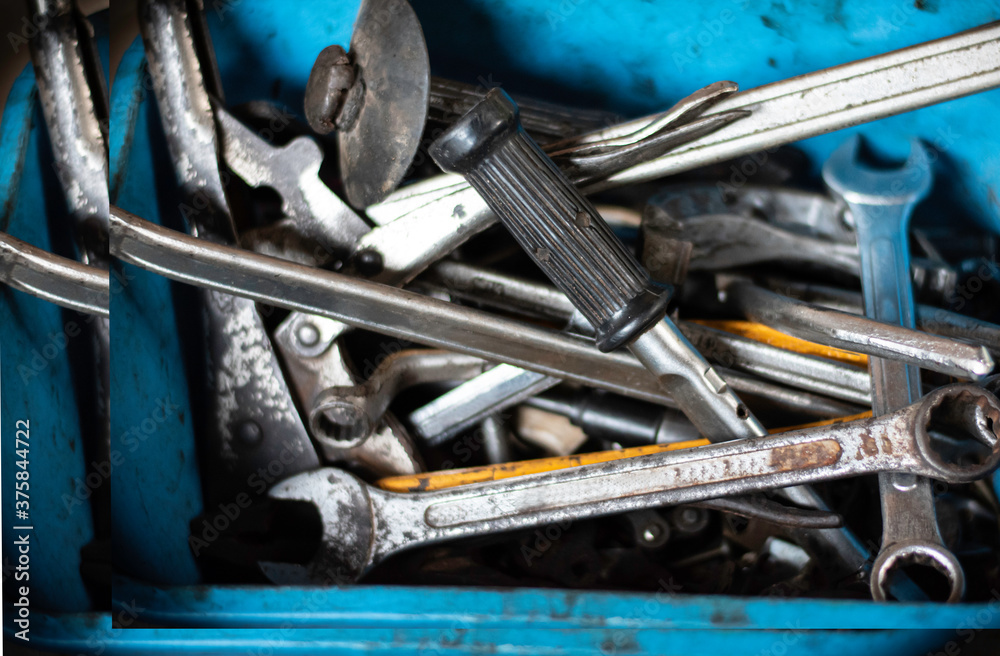 Fototapeta premium The hand tools are in a box full of dirt and rust.