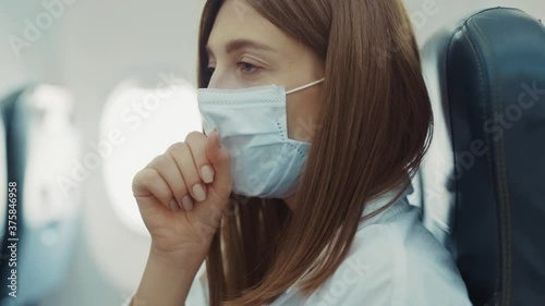 On plane young woman feeling unwell headache coughs wearing mask transportation protect coronavirus vacation airplane ill sick holiday lady passenger slow motion