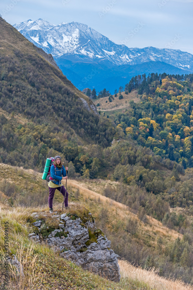 A women in trekking wear and mountains behind A women in trekking wear and mountains behind