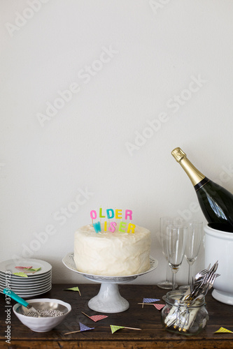 Cake corner at a party with cake and colourful birthday candles saying 
