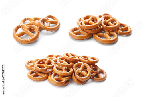 Set of tasty pretzel crackers on white background