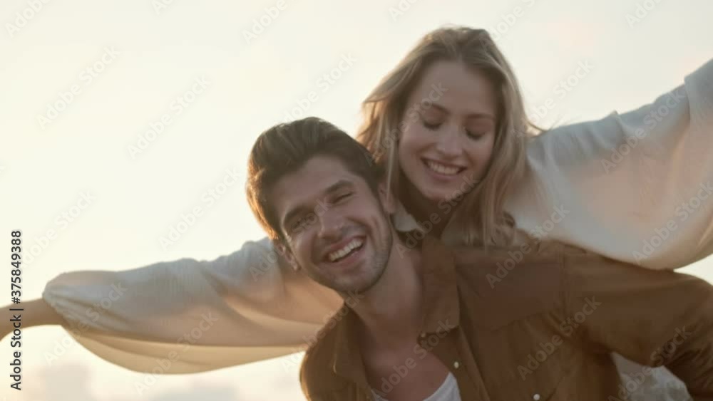 Close-up view of a joyful young couple man and woman have fun in the field