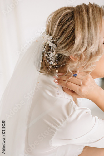 Decoration on the bride in a white dress