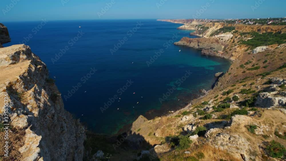 aerial pan view amazing seashore with high limestone cliffs over deep blue sea at sunny summer day. beauty of live nature aerial pan view amazing seashore with high limestone cliffs over deep blue sea at sunny summer day. beauty of live nature