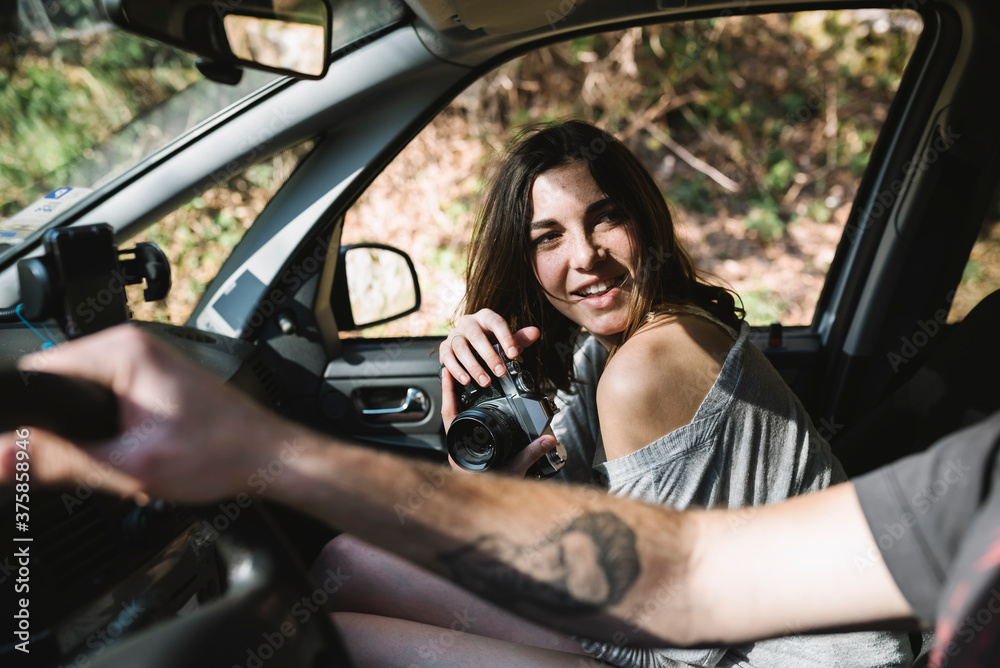 Young woman and man traveling together in car Young woman and man traveling together in car