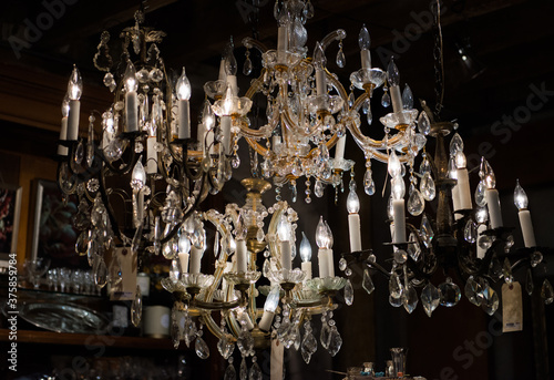 Old crystal chandeliers in an antique shop photo