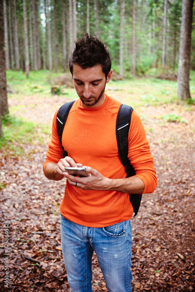 Man with cell phone in the forest Man with cell phone in the forest