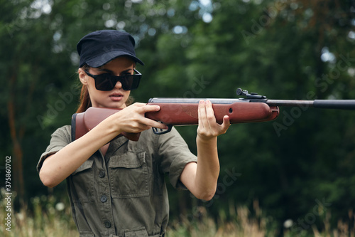 Woman soldier Weapon in hand hunting sunglasses black cap 