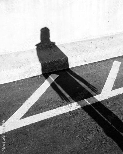 Long shadow of a person with claws