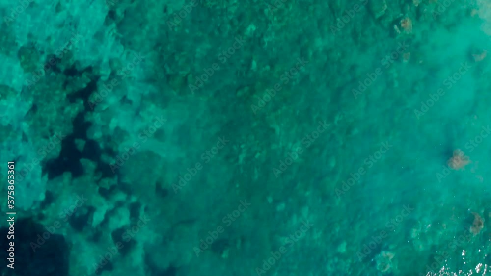 Colorful sea texture with rocks under azure calm water near shoreline in Mediterranean Colorful sea texture with rocks under azure calm water near shoreline in Mediterranean