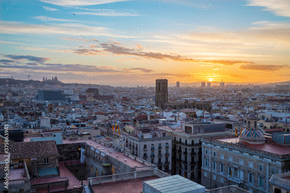 Barcelona - The sunset over the city with the Santa Maria del Pi gothic church in the centre.