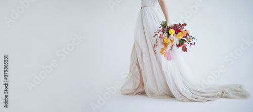 Bride walks with autumn bouquet banner