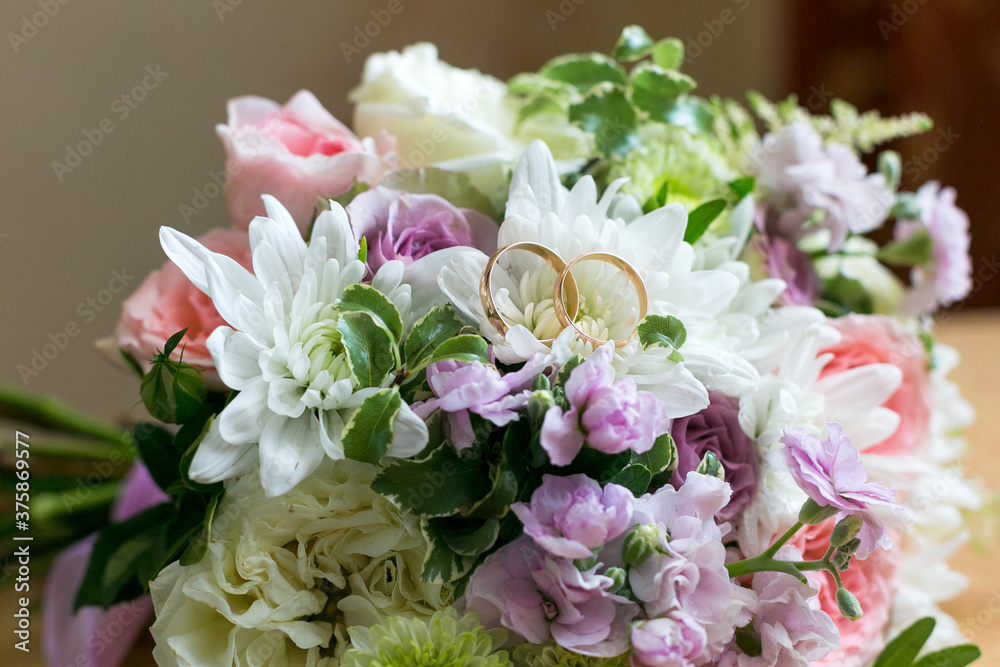 Wedding rings lie on the petals of a flower bridal bouquet, Wedding rings lie on the petals of a flower bridal bouquet,