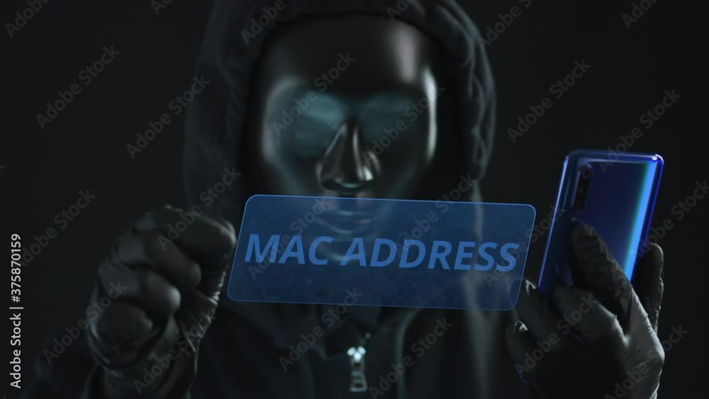 Hacker wearing black mask pulls MAC ADDRESS tab from a smartphone. Hacking concept