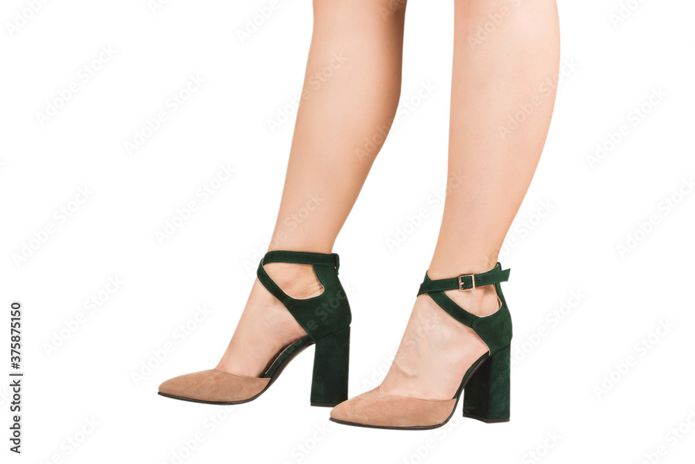 Woman legs in green and beige sandals on heels. Woman legs in green and beige sandals on heels.