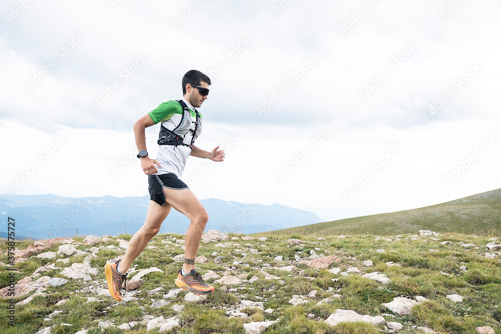 Athlete Runner Runs Rocks In Mountain Athlete Runner Runs Rocks In Mountain