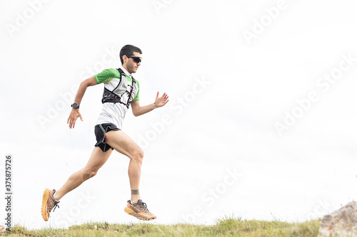Athlete Runner Runs Rocks In Mountain