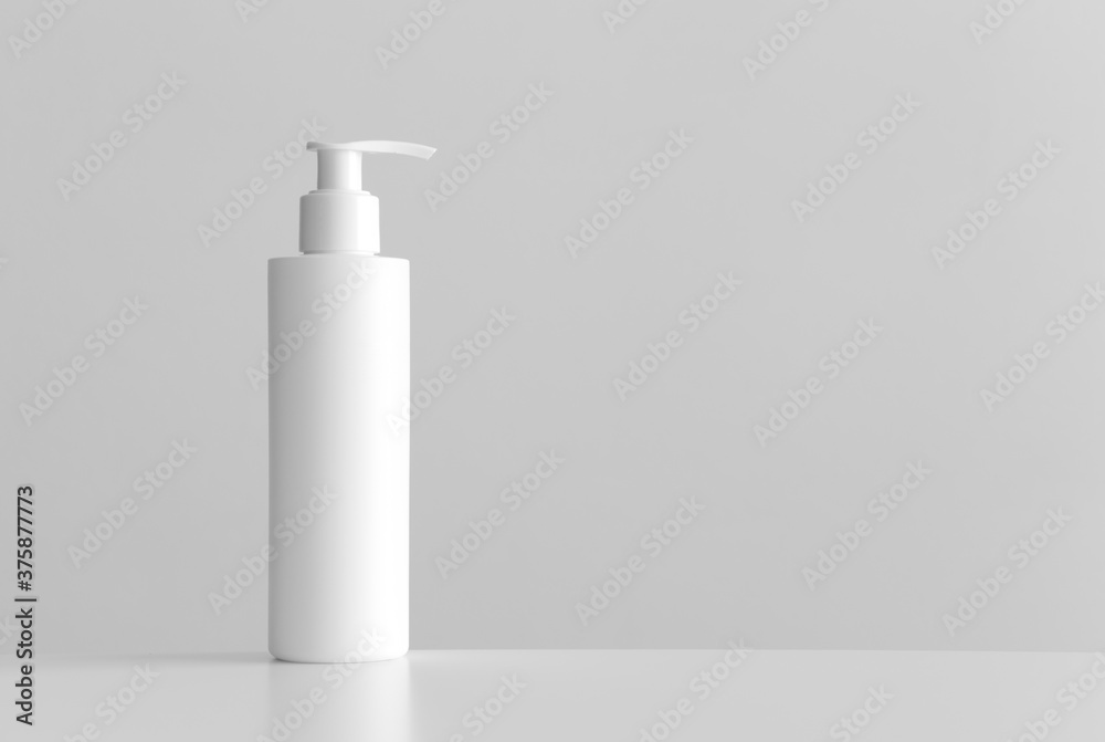 White cosmetic shampoo dispenser bottle mockup with blank copy space on a white table. White cosmetic shampoo dispenser bottle mockup with blank copy space on a white table.