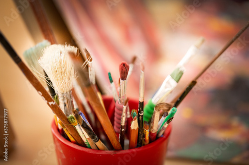 Close up of different paint brushes.