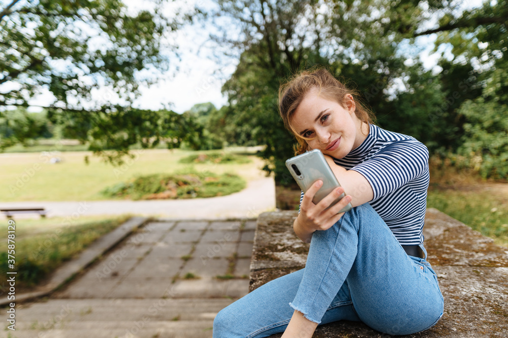 Slender attractive young woman relaxing outdoors Slender attractive young woman relaxing outdoors