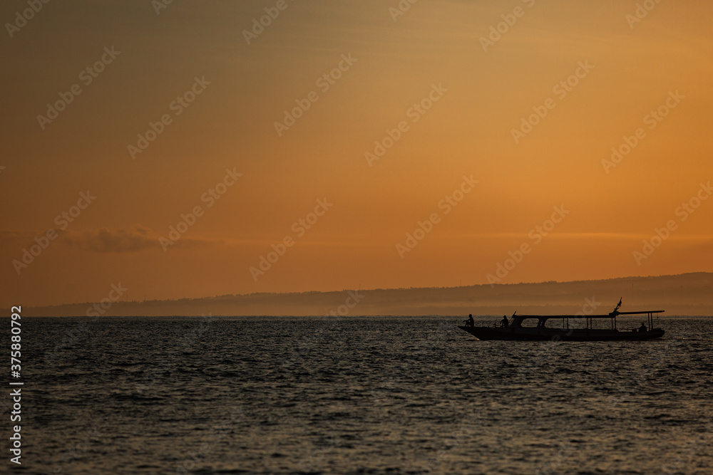 small boat floats on the water against the background of mountains small boat floats on the water against the background of mountains