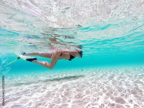woman snorkeling in clear blue water around Zanzibar