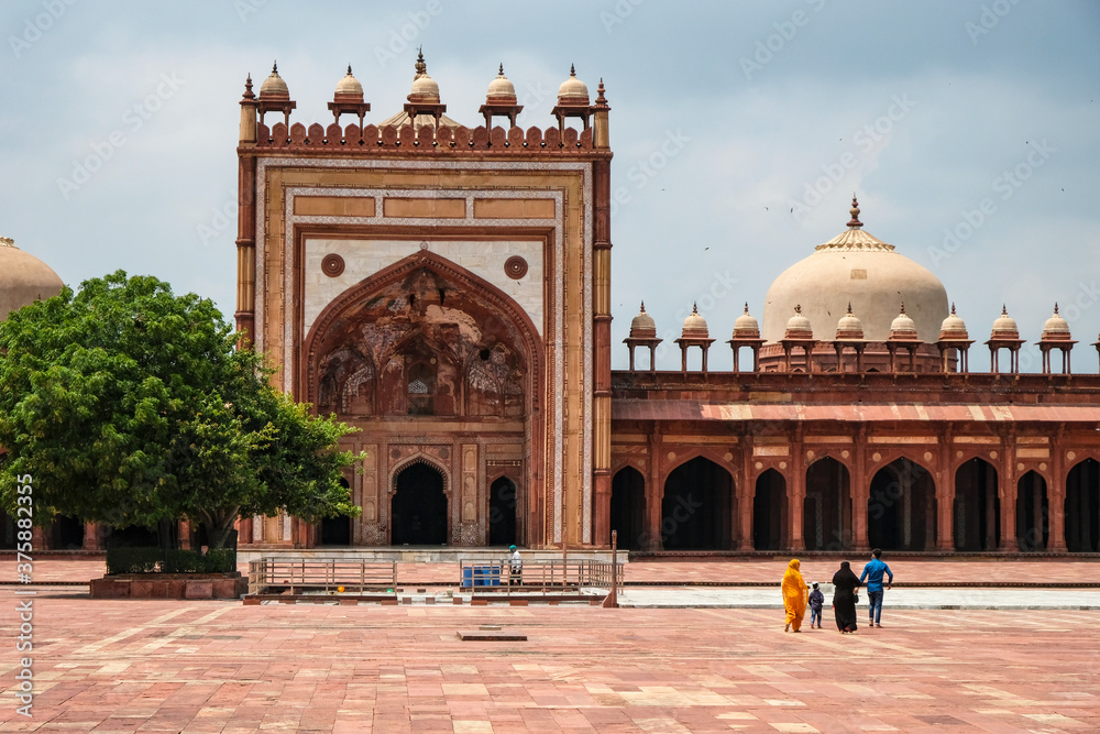 Fatehpur Sikri, India - September 2020: A family visiting the Jama Masjid mosque in Fatehpur Sikri on September 4, 2020 in Uttar Pradesh, India.