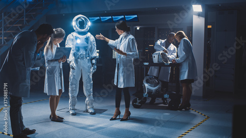 Obraz na płótnie Team of Aerospace Engineers Design New Space Suit Adapted for Galaxy Exploration and Travel