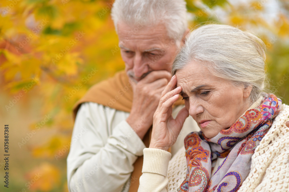 Portrait of sad senior couple in autumn park Portrait of sad senior couple in autumn park