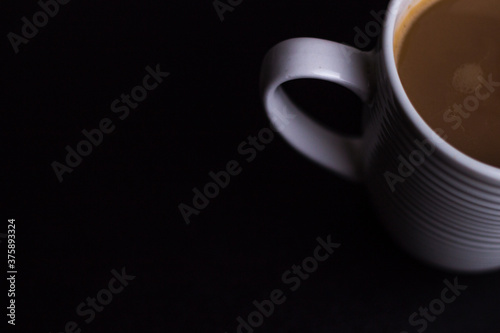 italian fresh coffee for breakfast in a white cup on the black background