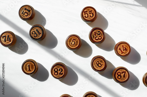 wooden Lotto barrels with sun shadows on a white background photo