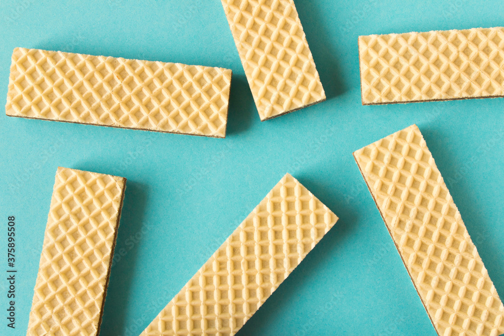 A few waffles with chocolate on blue background. Selective focus. A few waffles with chocolate on blue background. Selective focus.