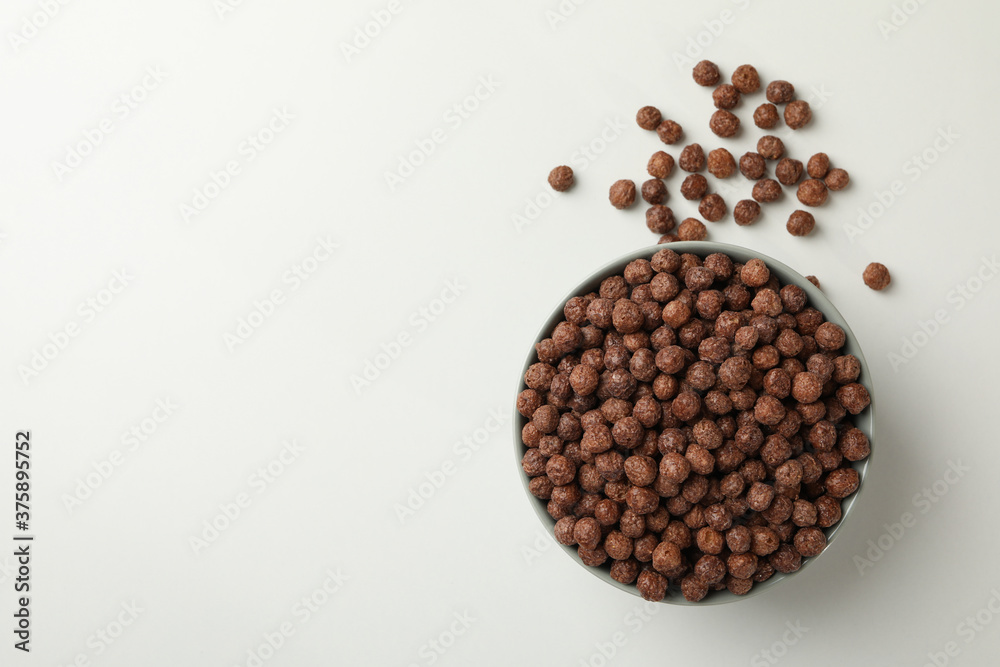 Bowl with corn balls on white background, top view