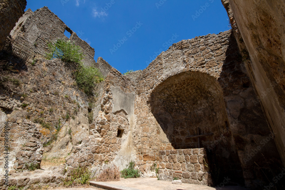 Ruins of an ancient medieval town called Antica Monterano or Monterano Vecchia,the city born in Etruscan times Inside the Monterano Nature Reserve.Lazio,Italy.