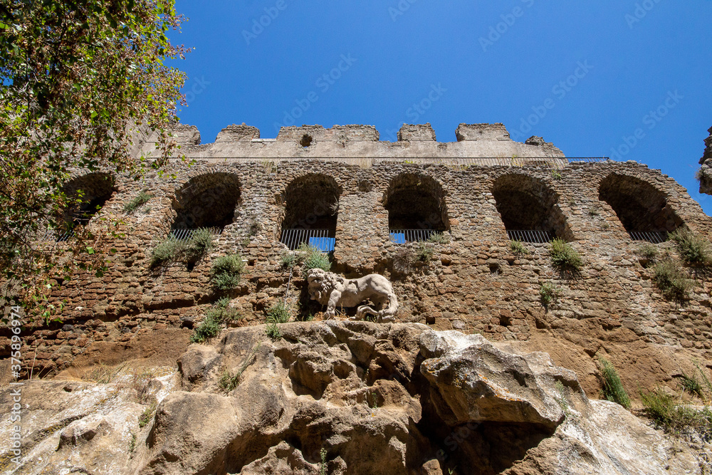 The castle with  Lion fountain by Bernini in Ancient Monterano,with the Lion on top the wall, represented in the act of shaking the rock with a paw to make the water emanate.