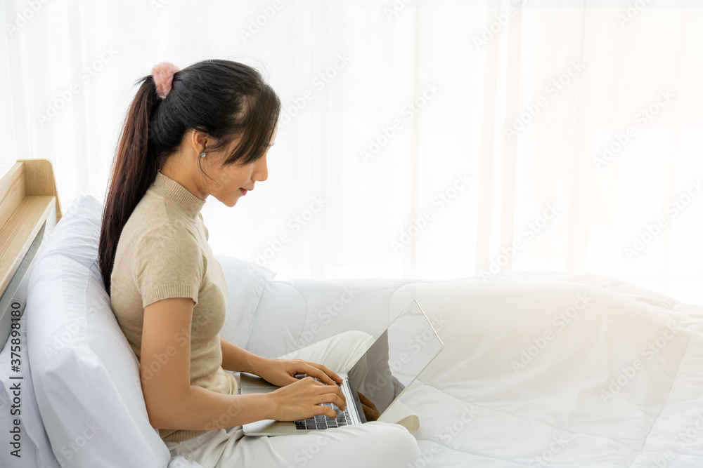 A girl sitting on bed with a laptop Receive orders from customers and deliver them to the address provided by the customer.