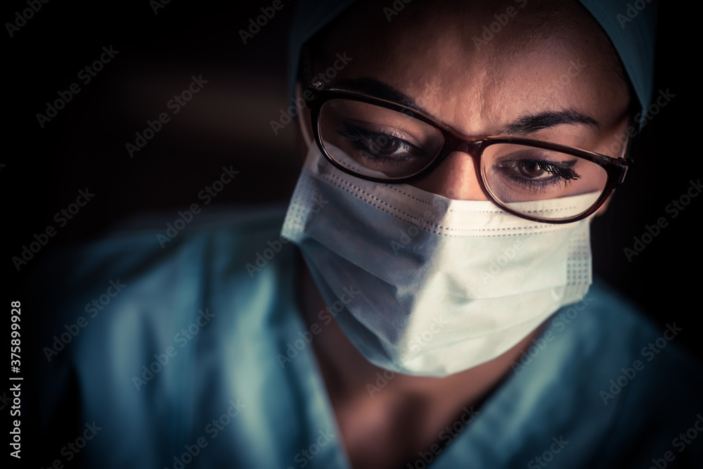 Young female medic, wearing a mask and glasses Young female medic, wearing a mask and glasses