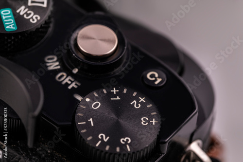 Macro close-up of the black body of the camera with buttons for control.Selective focus and a fragment of the framing.